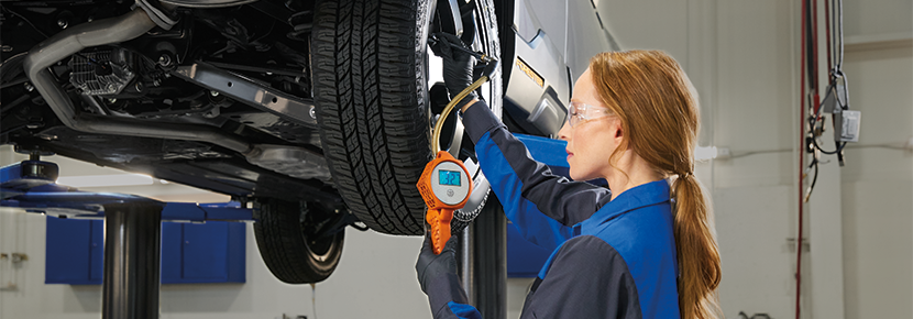 A Subaru technician checking tire pressure. | Jim Keras Subaru in Memphis TN