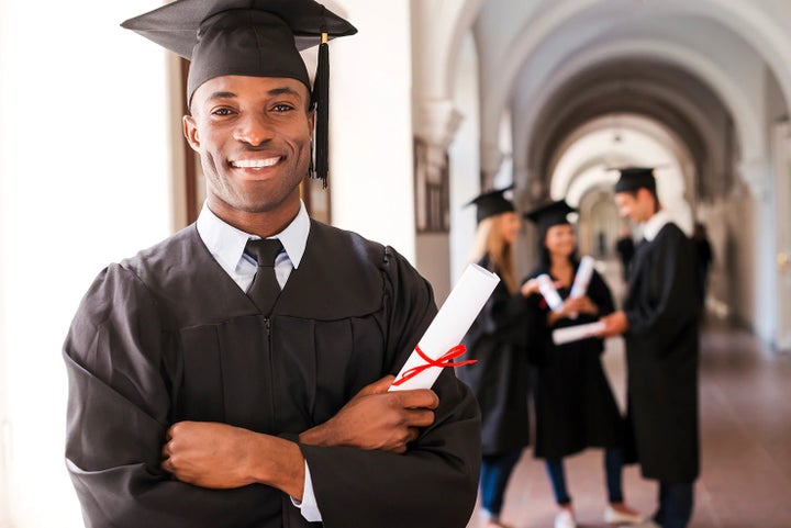 college graduate holding his diploma | Jim Keras Subaru in Memphis TN